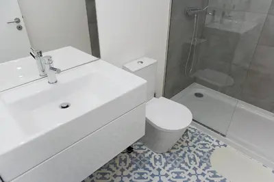 a bathroom with a sink and a toilet and a shower at My Modern Homey at Porto in Porto