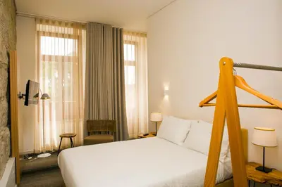 a hotel room with a bed and a window at BO - Álvares Cabral GuestHouse in Porto