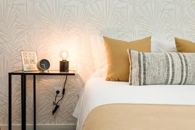 a bedroom with a bed with a night stand next to a bed with a bed at FT'Studio in Porto
