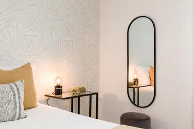 a bedroom with a bed and a mirror at FT'Studio in Porto
