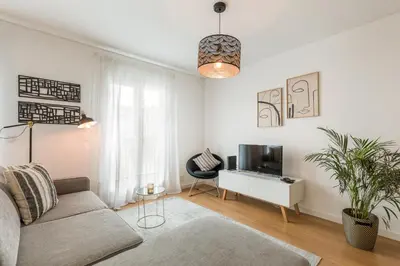 a living room with a couch and a tv at FT'Studio in Porto