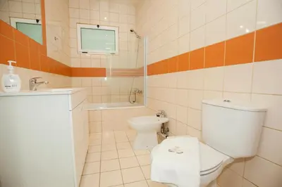 a bathroom with a toilet and a sink at ML Apartments Charming Rooms in Porto
