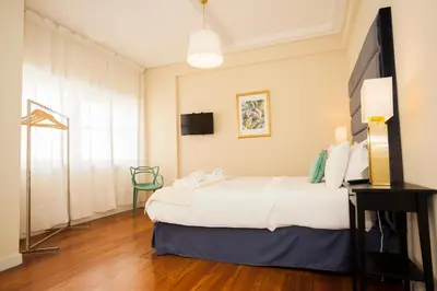 a hotel room with a bed and a television at ML Apartments Charming Rooms in Porto