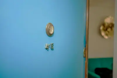 a blue door with a clock on it at ML Apartments Charming Rooms in Porto