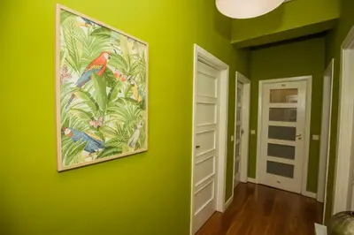 a green room with a painting on the wall at ML Apartments Charming Rooms in Porto