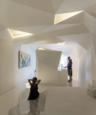 a woman sitting on the floor of a room at LeBlanche in Porto