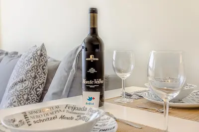 a living room with a couch and a large window at Trindade Flat with Great View in Porto
