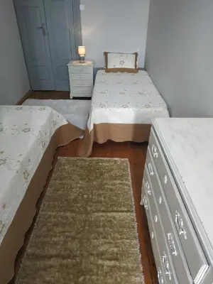 two beds and a dresser in a room at Gabriel Guesthouse in Porto