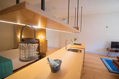 a kitchen with a sink and a stove in a room at Step In Porto Apartments in Porto