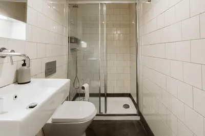 a bathroom with a shower and a toilet and a sink at Step In Porto Apartments in Porto
