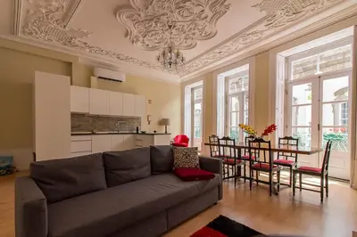 a living room with a couch and a table at São Domingos Flowers Apartments in Porto
