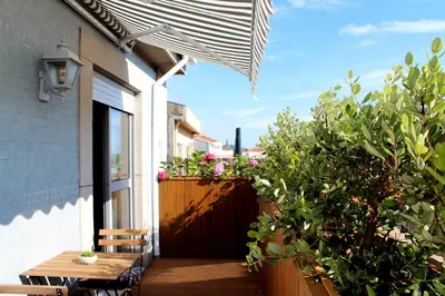 a patio with a wooden table and some plants at Rosario's Boutique Apartments in Porto