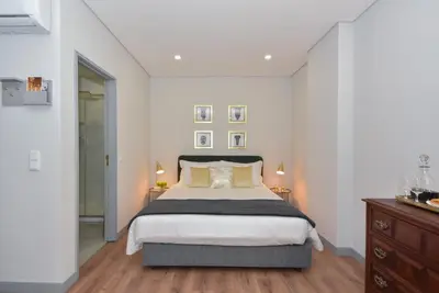 a bedroom with a large bed and two lamps at Rosario's Boutique Apartments in Porto