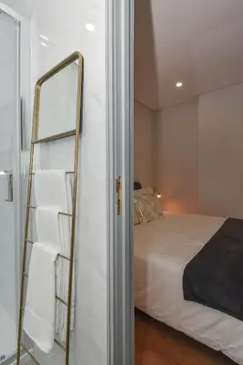 a bedroom with a ladder next to a bed at Rosario's Boutique Apartments in Porto