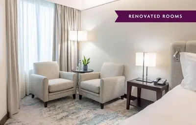 a bed with a white pillow and a side table at Crowne Plaza Porto by IHG in Porto