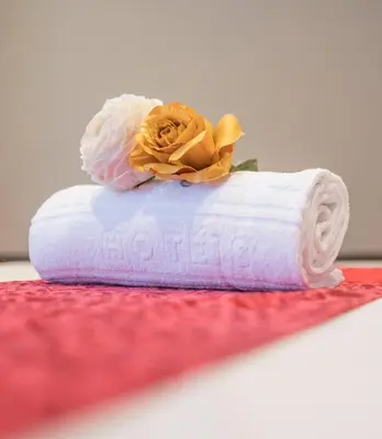 a roll of toilet paper with a flower on it at Vila Gale Porto - Centro in Porto