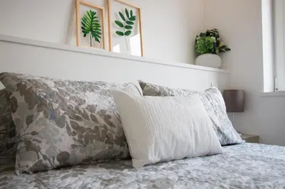a bed with two pillows on top of it at Casa d'Avó in Porto
