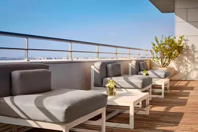 a balcony with chairs and tables on a building at Sheraton Porto Hotel & Spa in Porto
