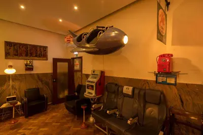 a barber shop with a hair salon with a car on the wall at Pao de Acucar Hotel in Porto