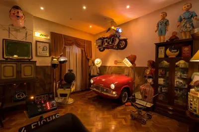an old fashioned room with a red car on the wall at Pao de Acucar Hotel in Porto