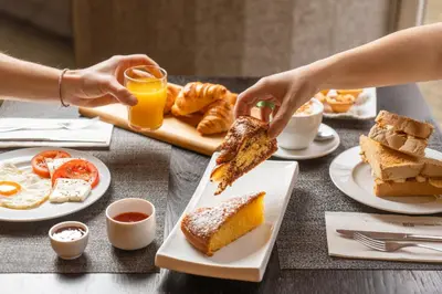 a table with a breakfast of eggs and bread at HF Fénix Porto in Porto