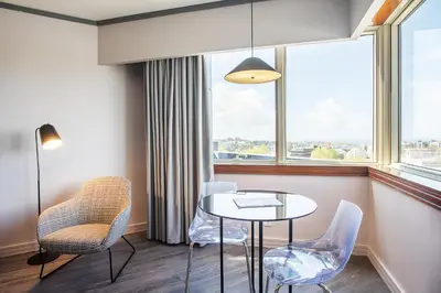 a room with a table and chairs and a window at HF Fénix Porto in Porto