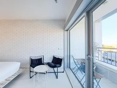 a room with two chairs and a table on a balcony at CM Antas Studios in Porto