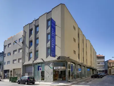 a building with a blue sign on the side of it at TRYP by Wyndham Porto Centro Hotel in Porto