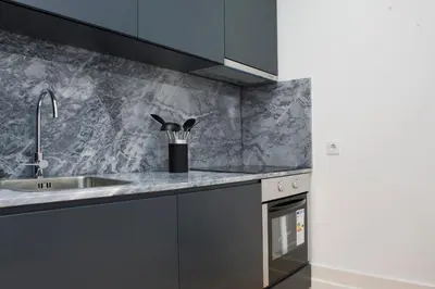 a kitchen with a sink and a counter top at Oporto Cool - Fontainhas in Porto