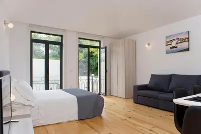 a bedroom with a bed and a couch at Oporto Cool - Fontainhas in Porto