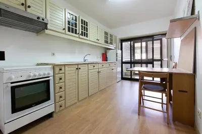 a kitchen with a table and a stove top oven at Cozy Apartment Casa da Música in Porto