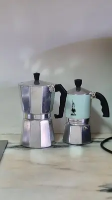 two coffee makers sitting next to each other on a counter at Cozy Apartment Casa da Música in Porto