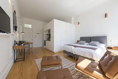 a bedroom with a bed and a living room at Tripas-Coração, São Bento Apartments in Porto