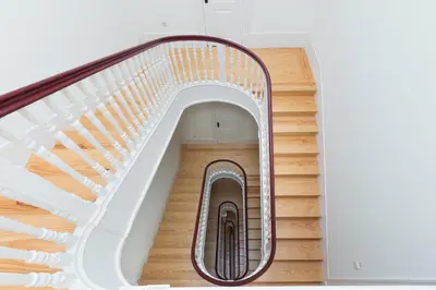 a spiral staircase in a building with a metal railing at B28 Apartments Porto in Porto