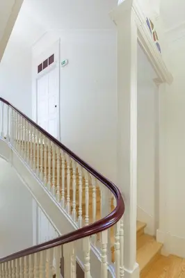 a staircase with white walls and a white door at B28 Apartments Porto in Porto