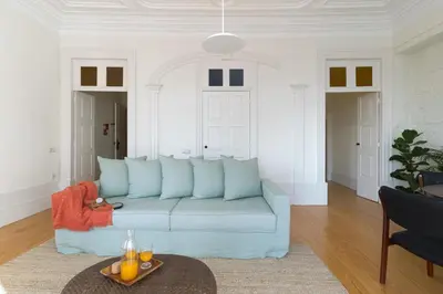 a living room with a blue couch and a table at B28 Apartments Porto in Porto