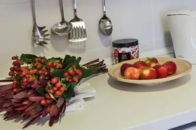 a counter with a bowl of apples and a bowl of fruit at bnapartments Rio in Porto
