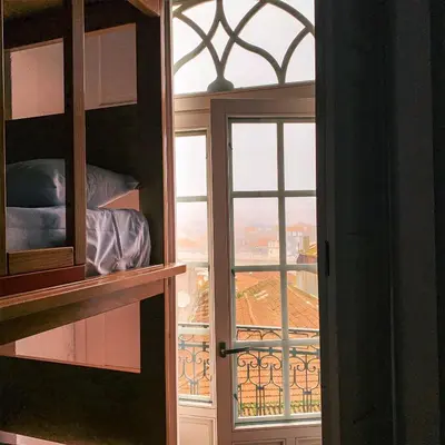 a door to a room with a view of a balcony at CATS Porto Hostel in Porto