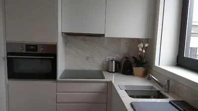 a kitchen with white cabinets and a sink at S Bento Boutique Apartment in Porto
