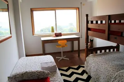 a bedroom with a desk and a bed and a desk with a window at Historical Porto/Gaia Apartment in Porto