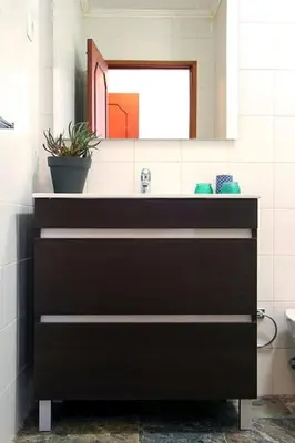 a bathroom with a black sink and a mirror at Historical Porto/Gaia Apartment in Porto