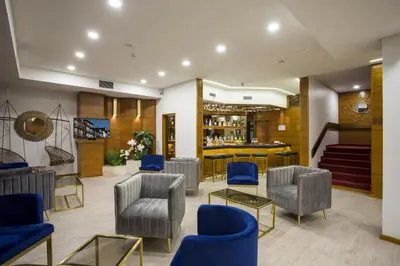 a waiting room with blue chairs and a bar at Casual Inca Porto in Porto