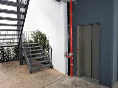 a staircase next to a building with a fire hydrant at Oporto Delight 1 Luxury Apartment in Historic Center with Balcony Max 4 p in Porto