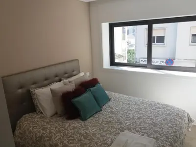 a bedroom with a bed with pillows and a window at SantOporto Baixa in Porto