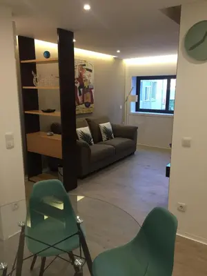 a living room with a couch and two chairs at SantOporto Baixa in Porto