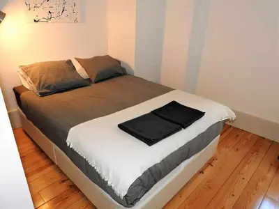 a bedroom with a large bed with white sheets at Oporto Delight 3 Luxury Apartment in Historic Center Max 4p in Porto