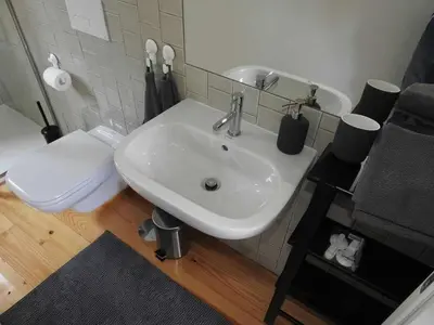 a bathroom with a white sink and a toilet at Oporto Delight 3 Luxury Apartment in Historic Center Max 4p in Porto