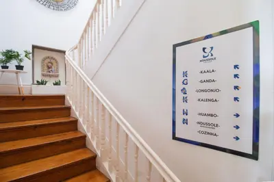 a white staircase in a home with a white ceiling at Ndussole Guest House in Porto
