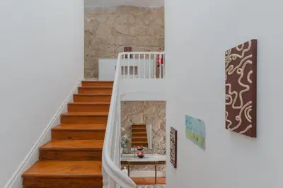 a staircase with white railings in a home at Ndussole Guest House in Porto