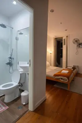 a bathroom with a bed and a sink and a toilet at Ndussole Guest House in Porto